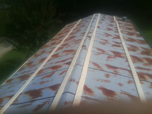 Rusted metal roof panels with new wood purlins before replacement — Storm Damage Roof Repair in Mc Dermott by Roofing Brothers